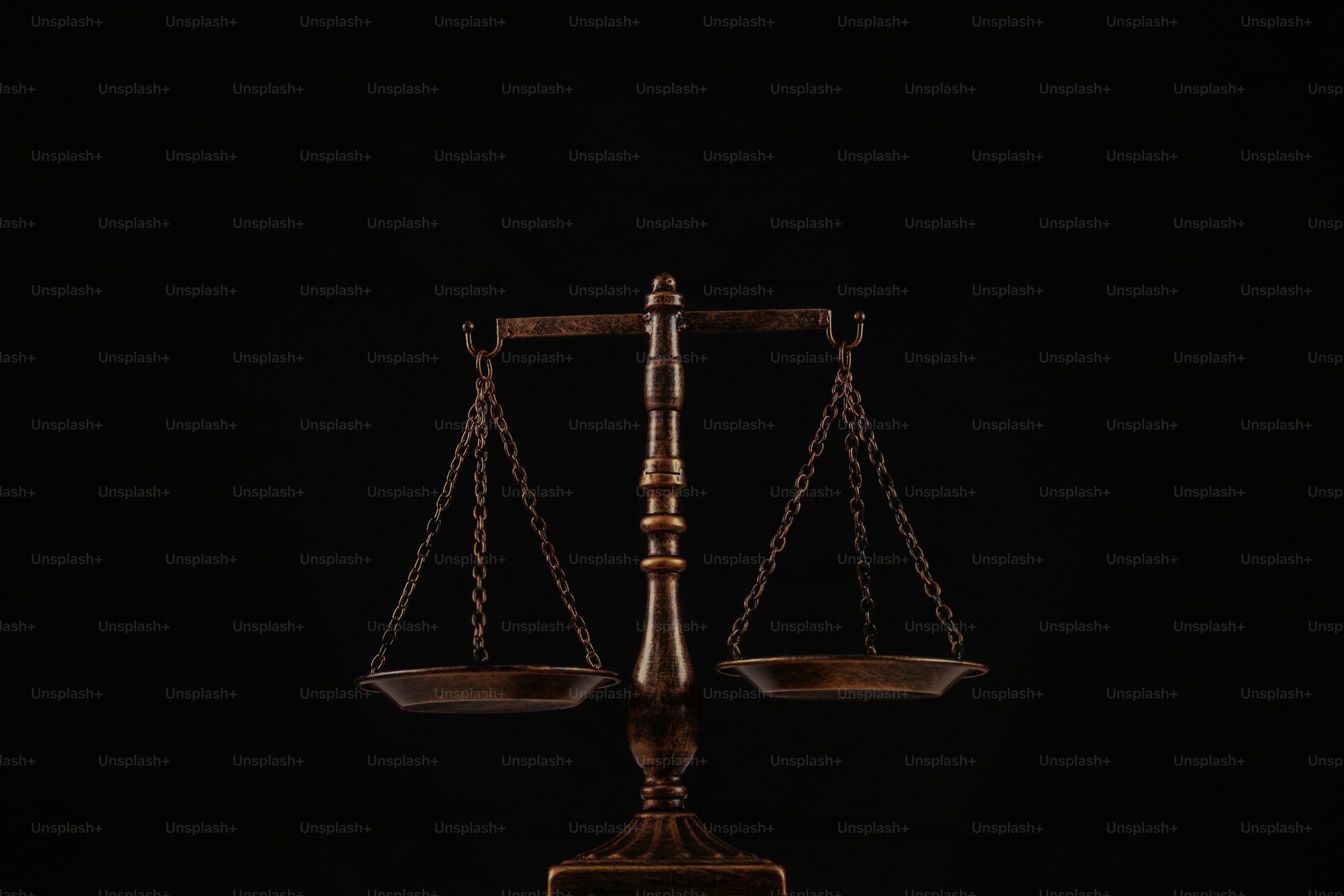 a wooden balance scale with a black background